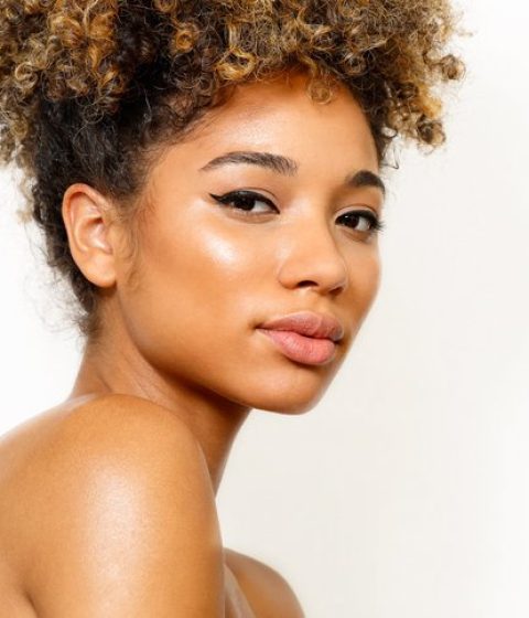 Female model with clean makeup and afro updo